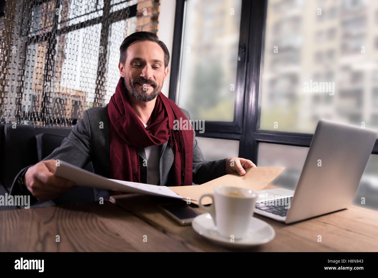 Handsome brunette man looking at some papers Stock Photo