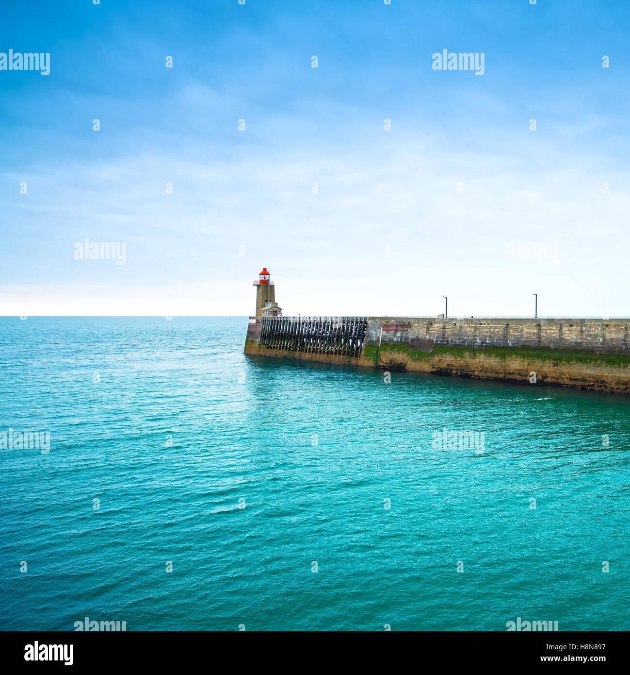 Pier and lighthouse on sunset, panoramic view. Fecamp harbor. Normandy France Stock Photo
