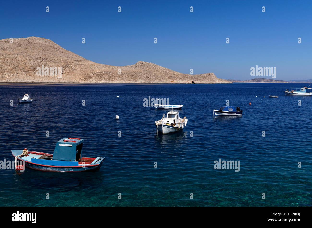 Small blue fishing boat, Village of Emborio, Chalki Island near Rhodes, Dodecanese Islands, Greece. Stock Photo