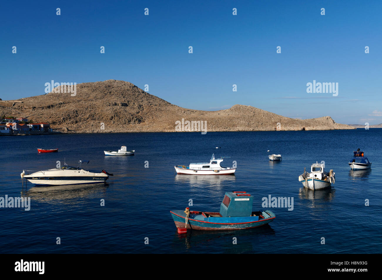 Small blue fishing boat, Village of Emborio, Chalki Island near Rhodes, Dodecanese Islands, Greece. Stock Photo