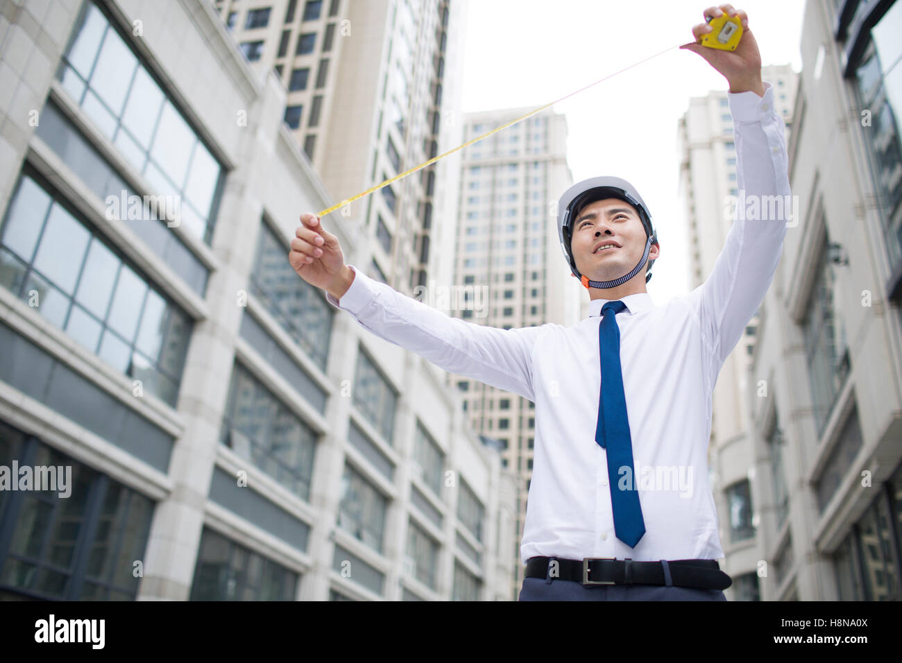 Chinese male architect measuring with ruler Stock Photo - Alamy