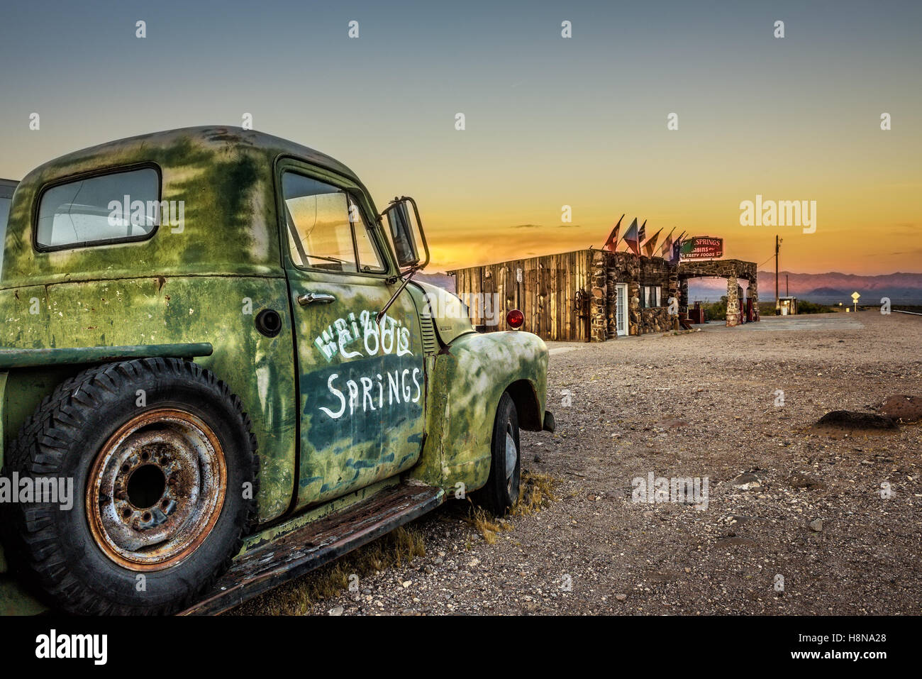 Car wreck and rebuilt Cool Springs station in the Mojave desert on historic route 66 Stock Photo