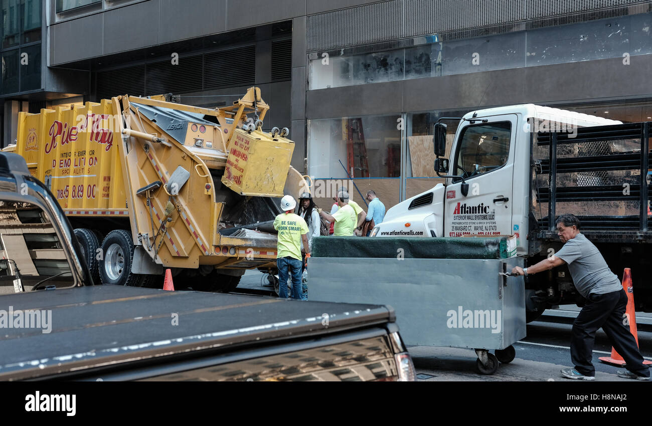 Dump truck and operatives seen loading waste in downtown New York City