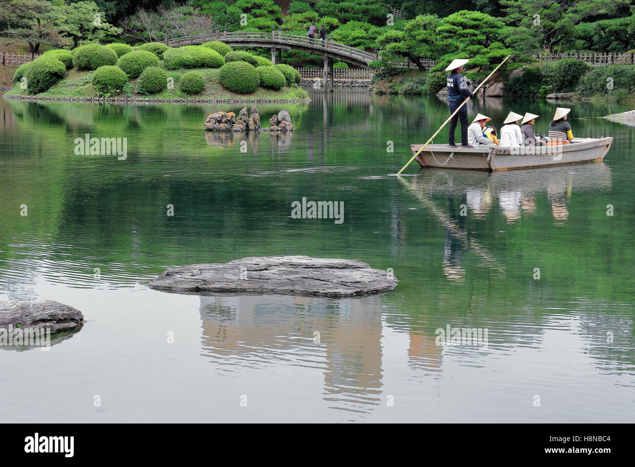 TAKAMATSU, JAPAN-OCTOBER 19: Ritsurin Koen-Chestnut Grove Garden offers boat trips to the visitors on the Nanko-South Pond. Stock Photo