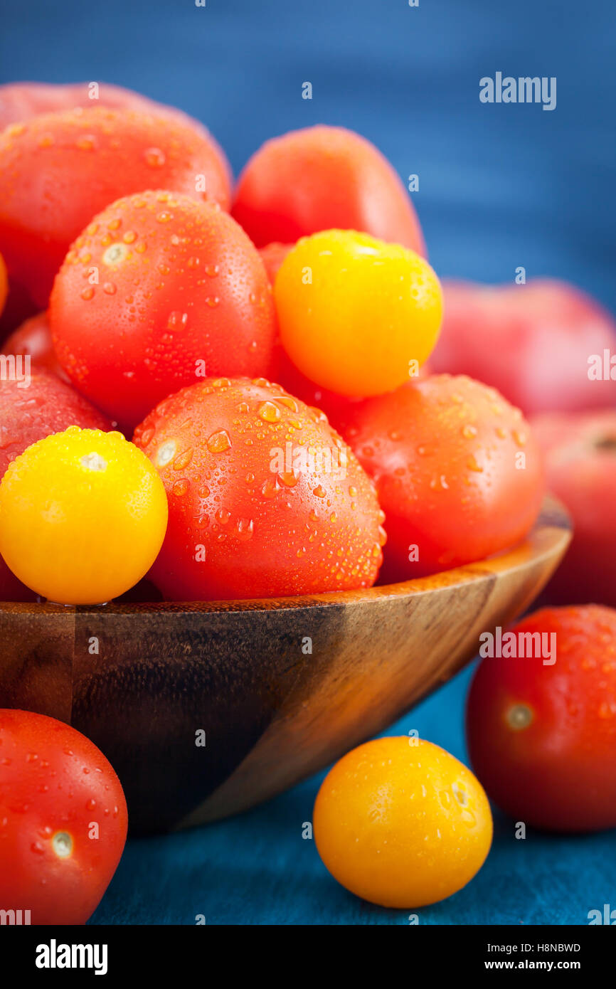 Fresh ripe red and yellow tomatoes in wooden bowl Stock Photo - Alamy