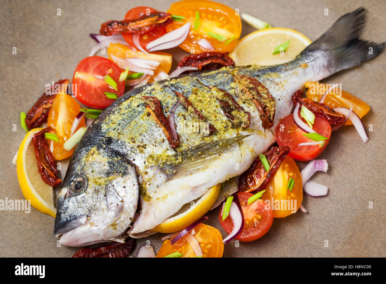Raw whole sea bream fish and vegetables ingredients, ready to cook ...