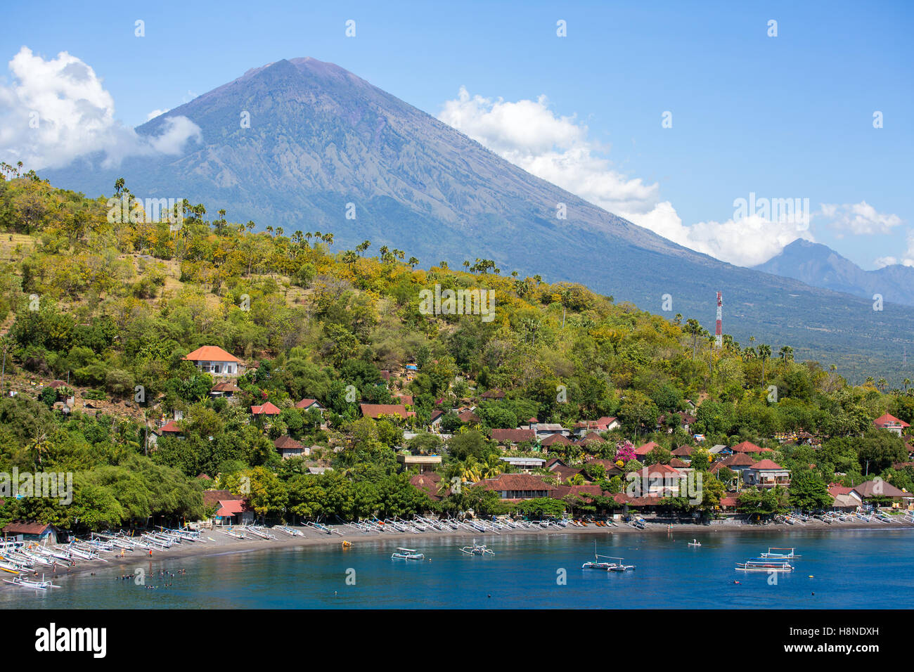 Jemeluk Beach and beautiful blue lagoon with Gunung Agung volcano on background. Amed village, East of Bali, Indonesia. Stock Photo