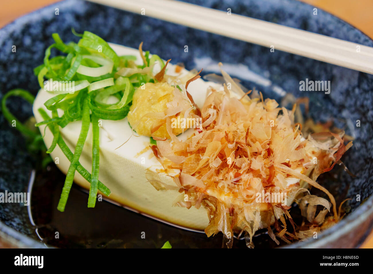 Delicious Tofu served with dried bonito, green onions and yolk, ate at Kyoto, Japan Stock Photo