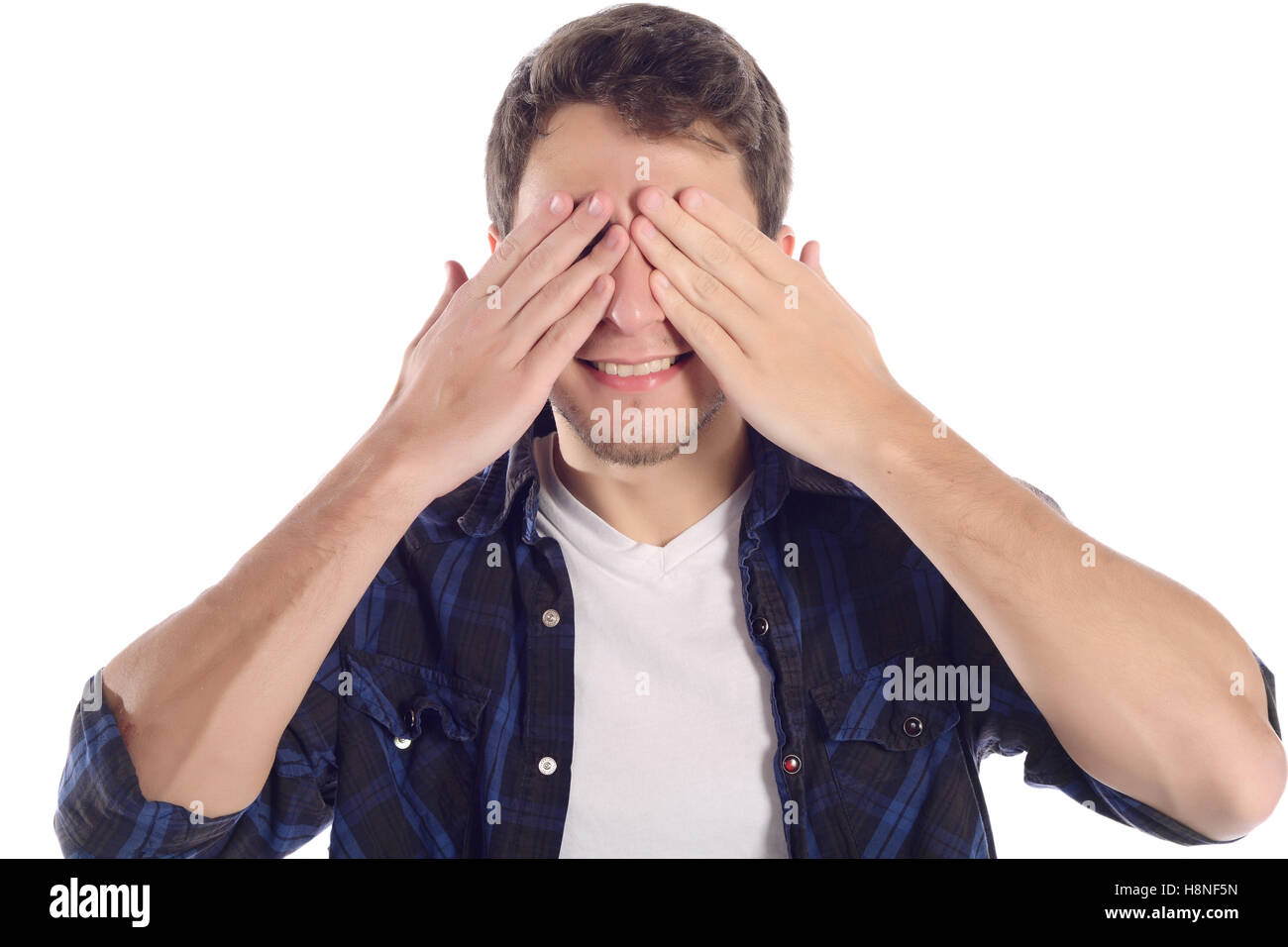 Portrait of a young man covering his eyes with hands. Isolated white