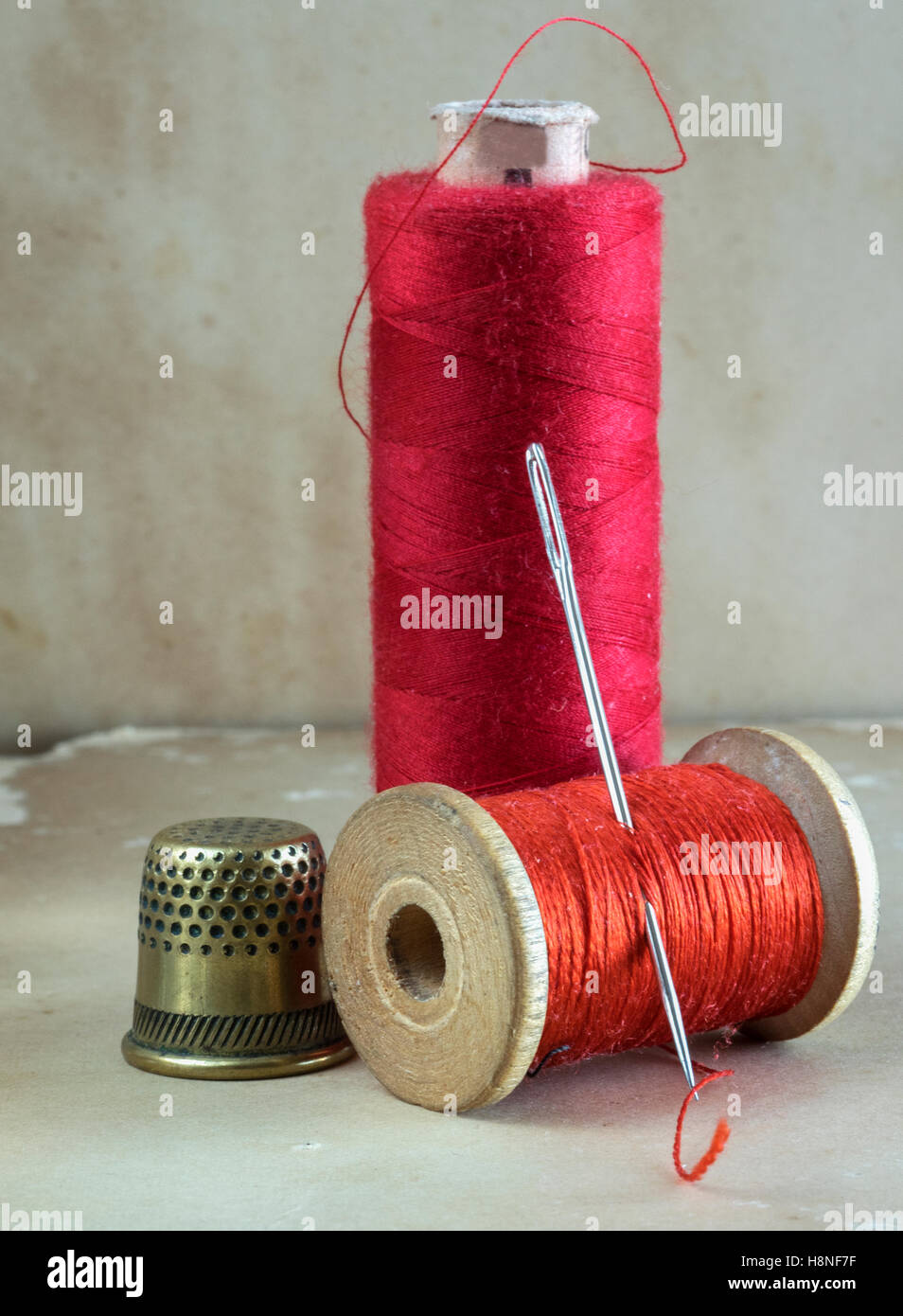 threads for sewing with needle and thimble Stock Photo