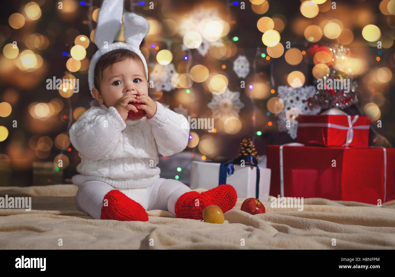 The little boy (baby) in the New Year's bunny suit on the background of