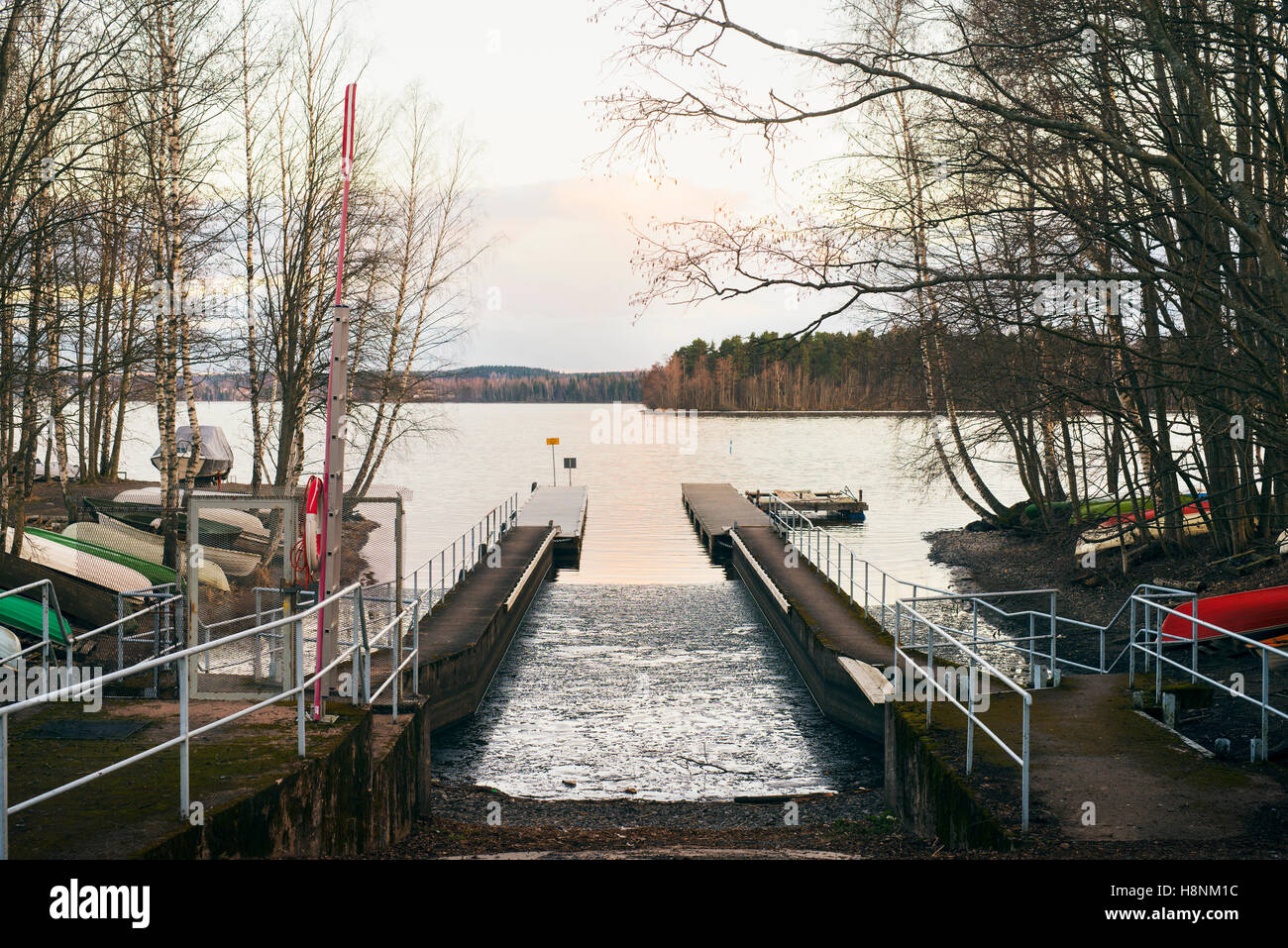 Harbour on lake among forests Stock Photo