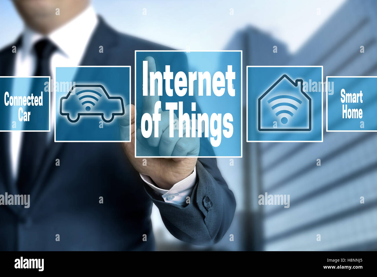 Internet of things touchscreen is operated by businessman. Stock Photo