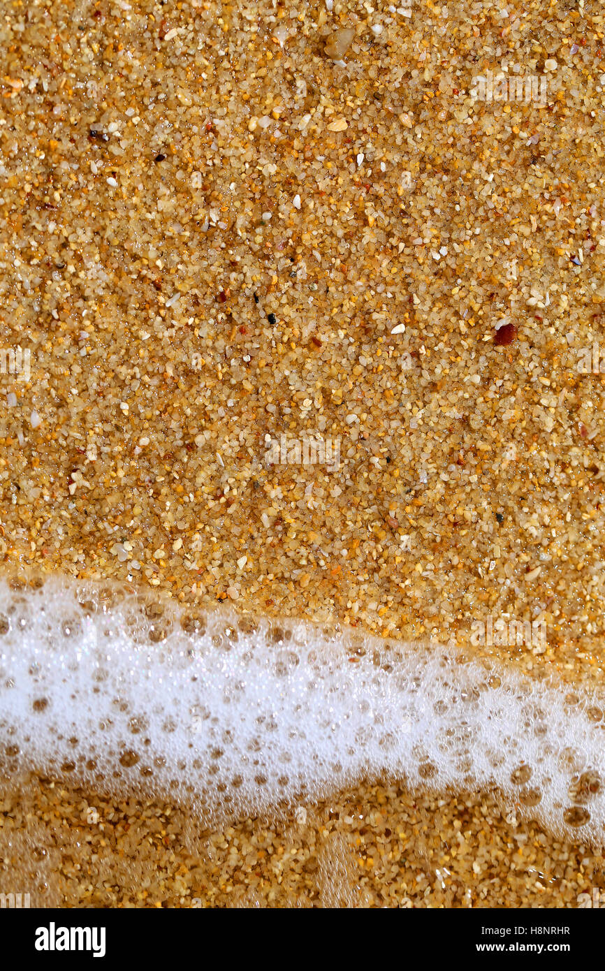 Beautiful waves on the yellow sea sand photographed in close-up Stock Photo