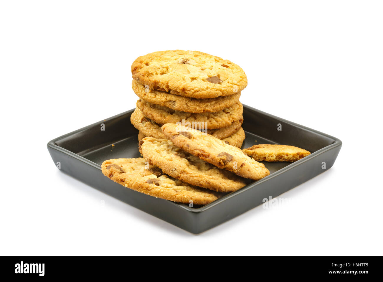 Milk chocolate almond cookies tower in black plate on white background Stock Photo