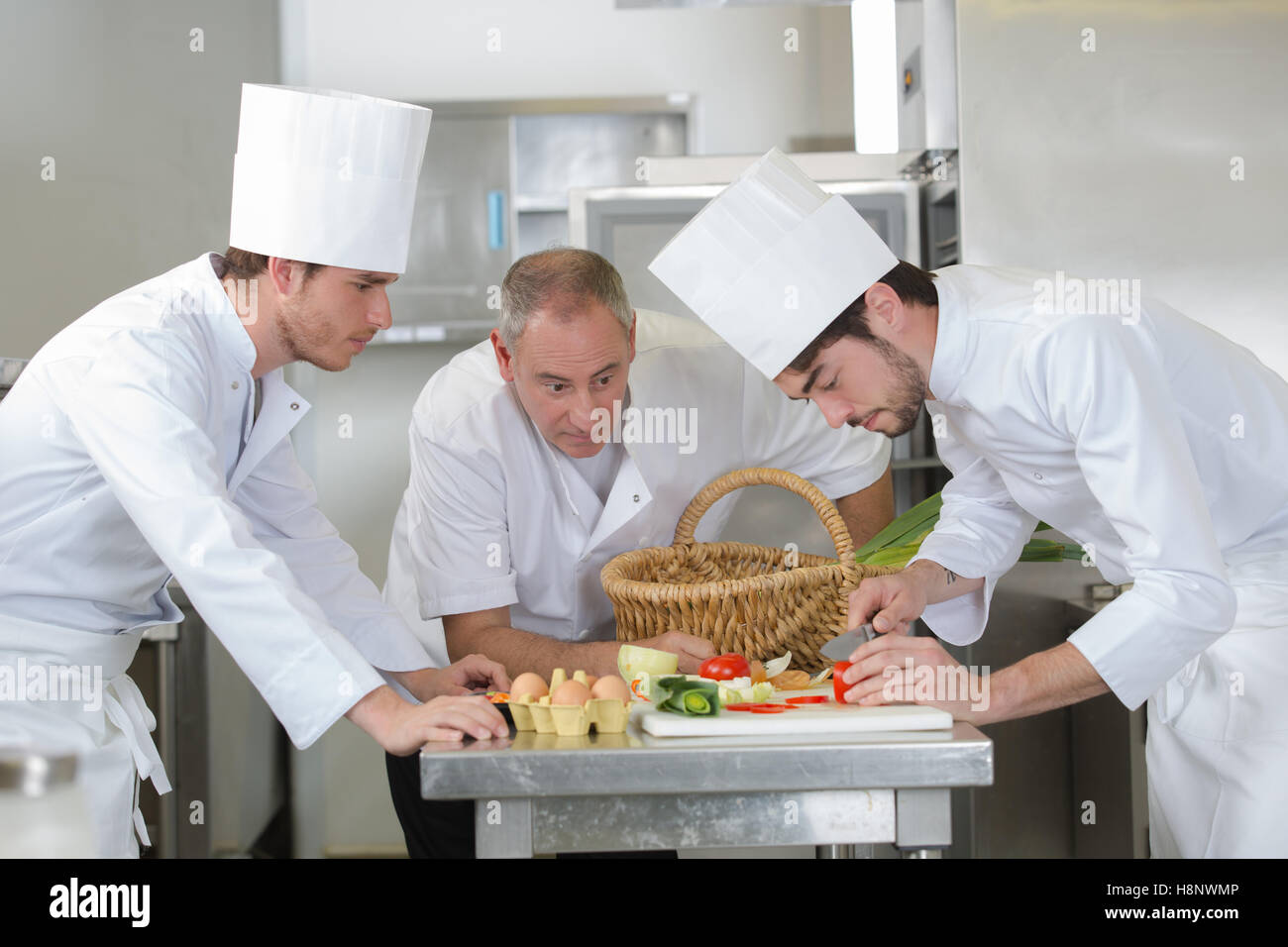 chef supervising trainees cooking Stock Photo