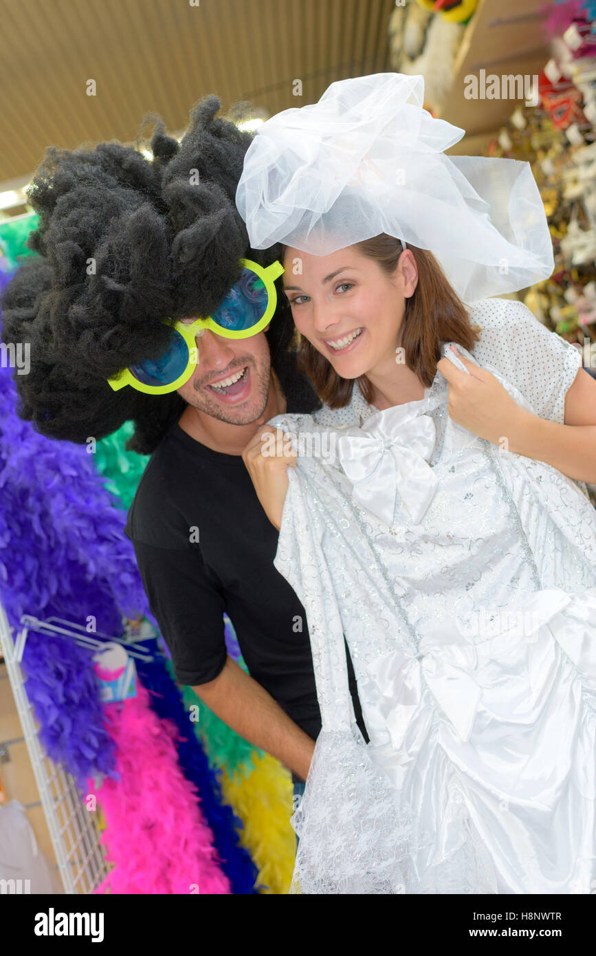 portrait of happy couple having fun trying costumes Stock Photo - Alamy