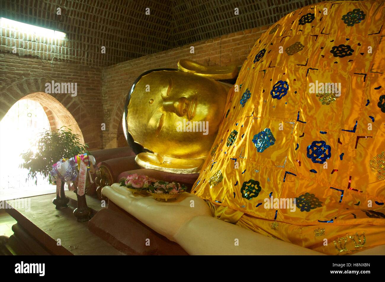 Bagan, Myanmar - November 12, 2014. Gigantic reclining Buddha image in restored pagoda, Bagan. Stock Photo
