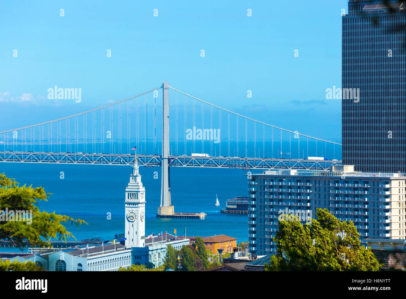 The Bay Bridge above seen behind Ferry Building next to downtown San Francisco, California. Copy Space Stock Photo