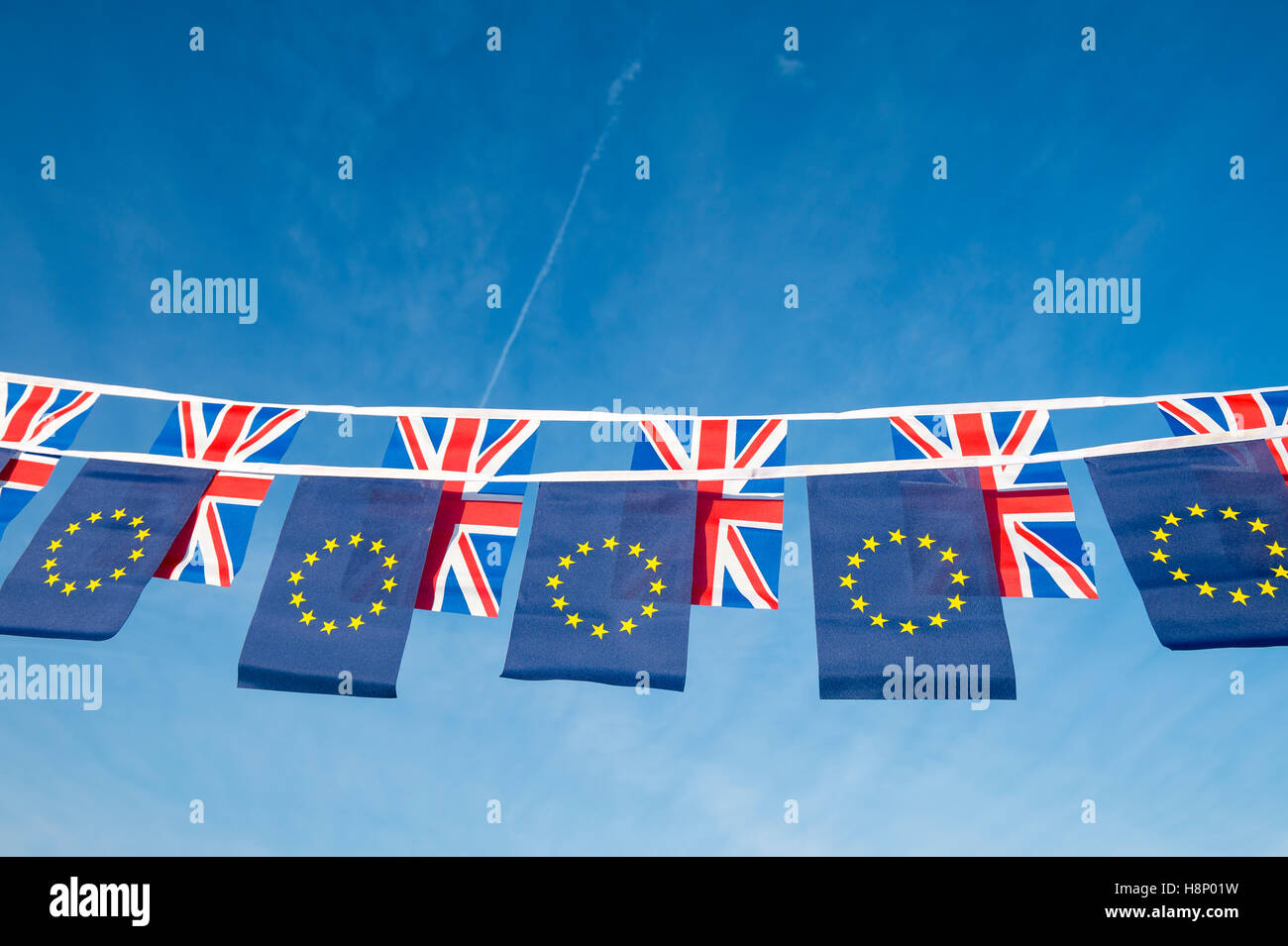 European Union and British Union Jack flag bunting flying in bright blue sky in a statement of the Brexit EU referendum Stock Photo