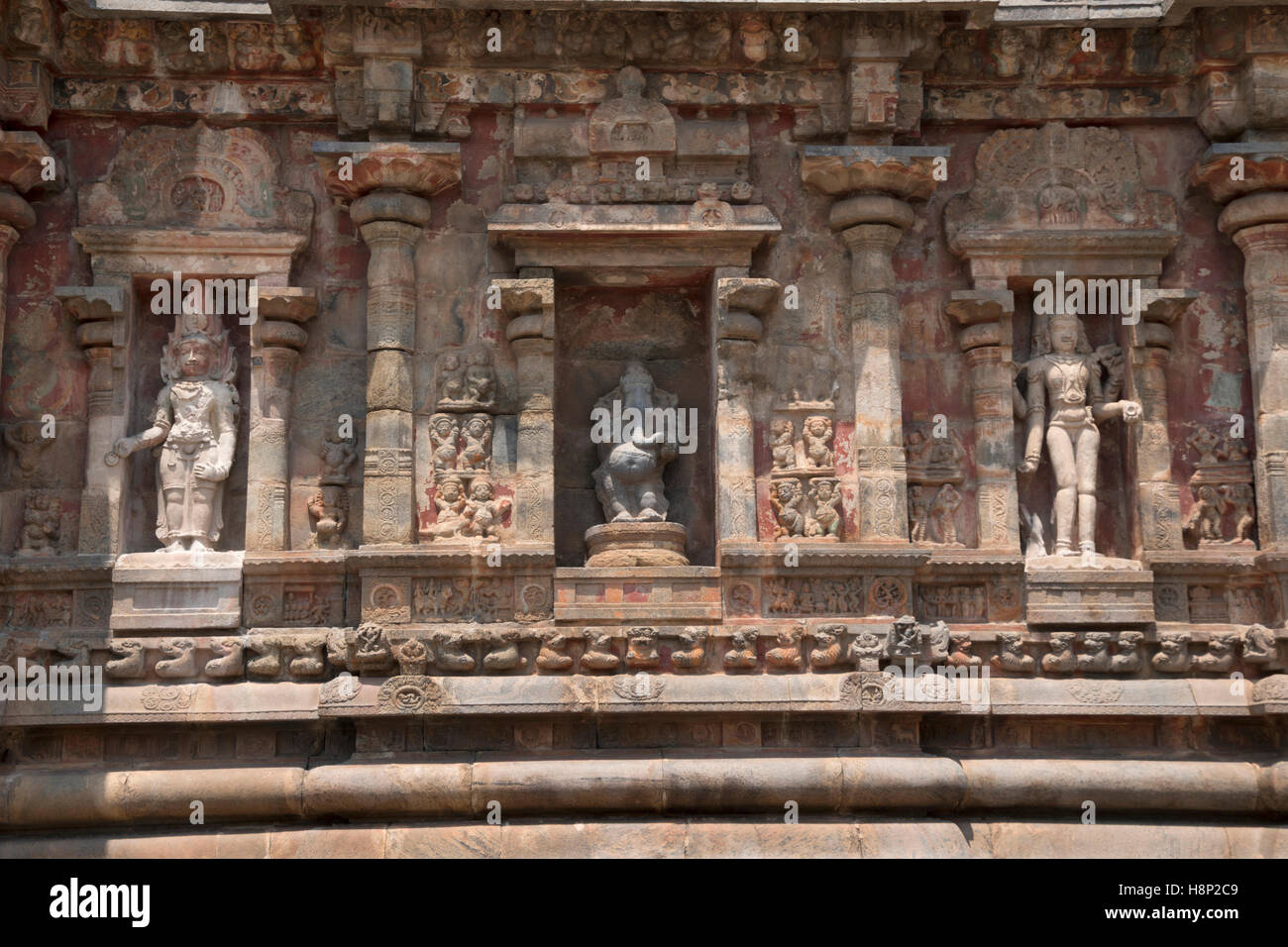 Deities, Southern niche of shrine wall, Airavatesvara Temple, Darasuram, Tamil Nadu, India. From left - Yama, Ganesha, Bhikshata Stock Photo