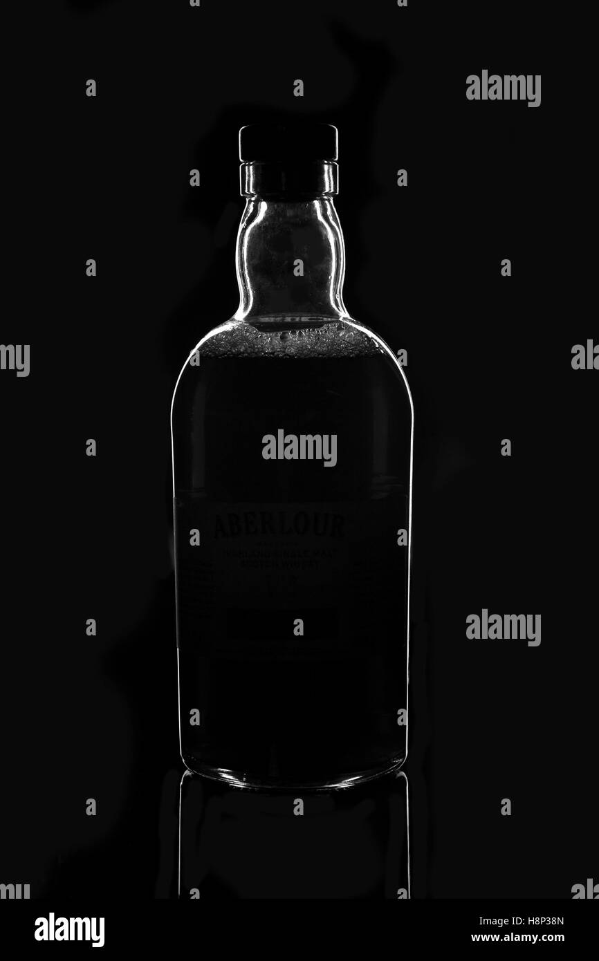Darkly lit glass bottle of whiskey Stock Photo Alamy