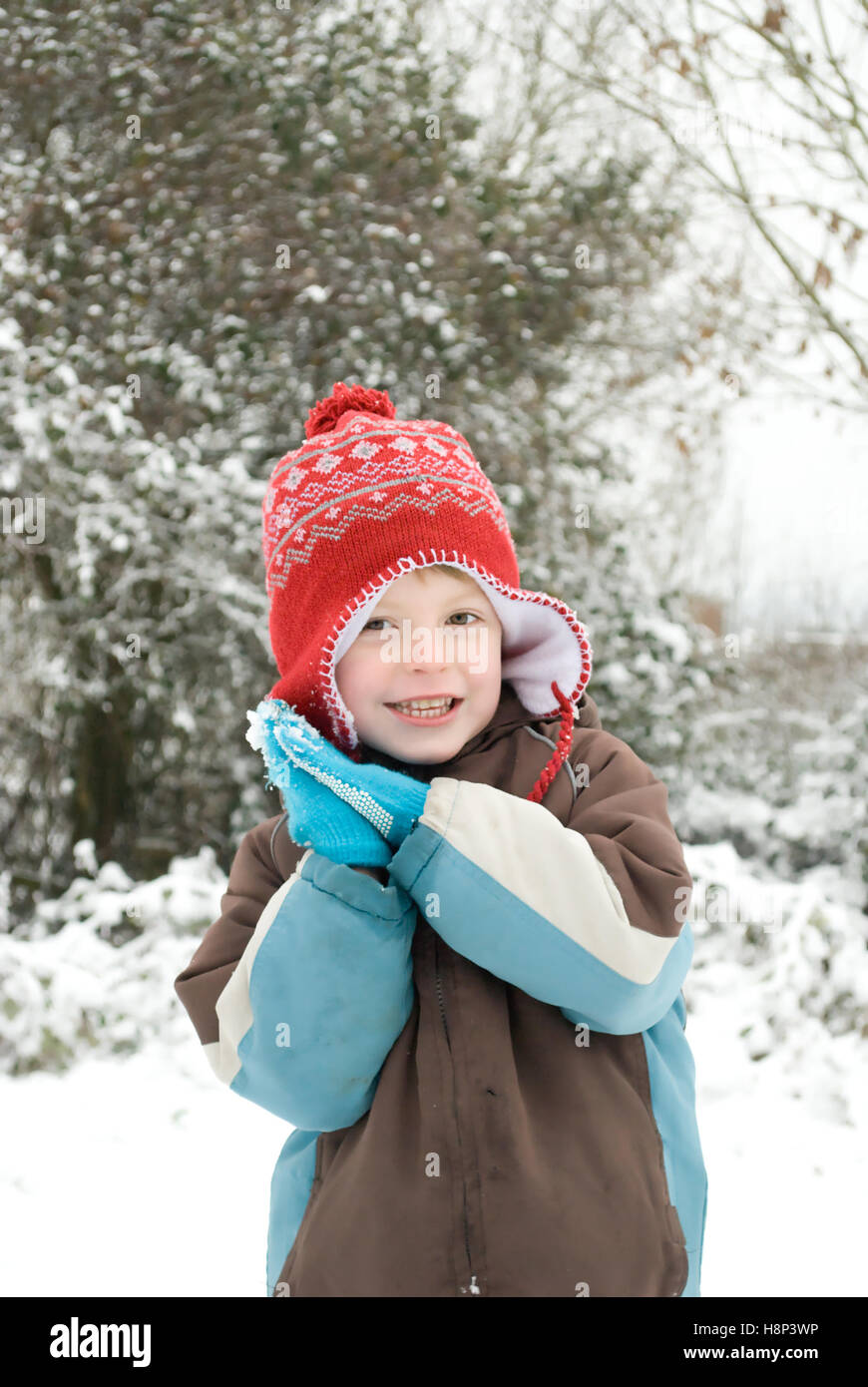 Portrait of a happy boy outdoors in the snow. Stock Photo