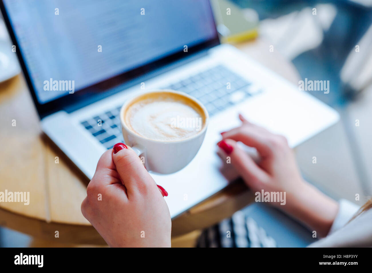 Unrecognizable Woman Drinking Coffee in Coffee Shop Stock Photo