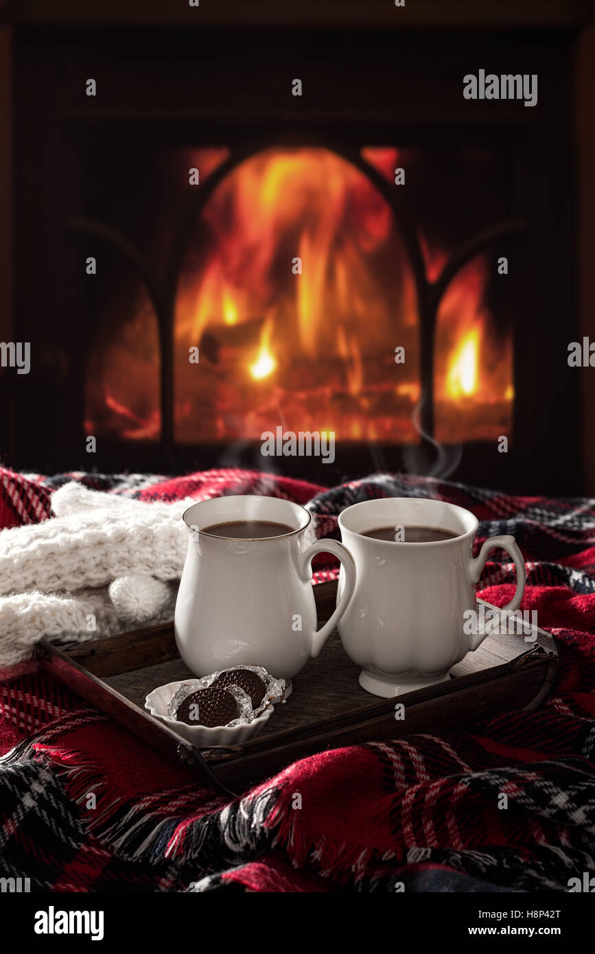 Hot chocolate drinks by the fireside Stock Photo