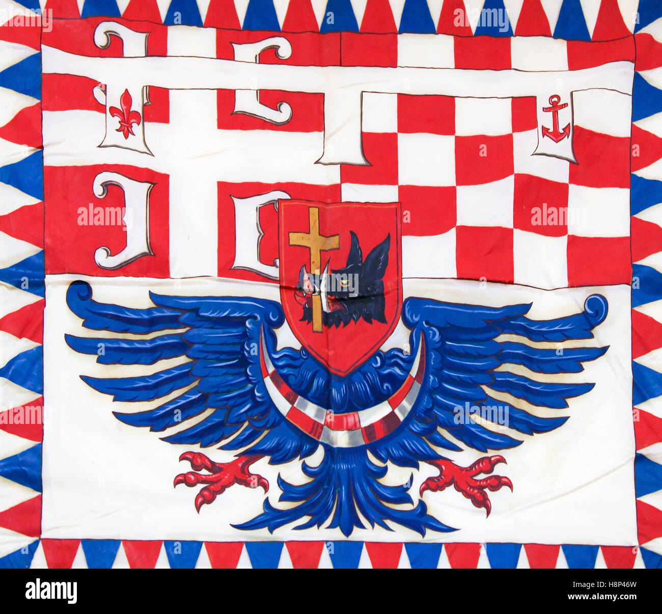 Tricolour flag in Belgrade, Serbia, with depictions of a pig, a cross and an eagle. Stock Photo