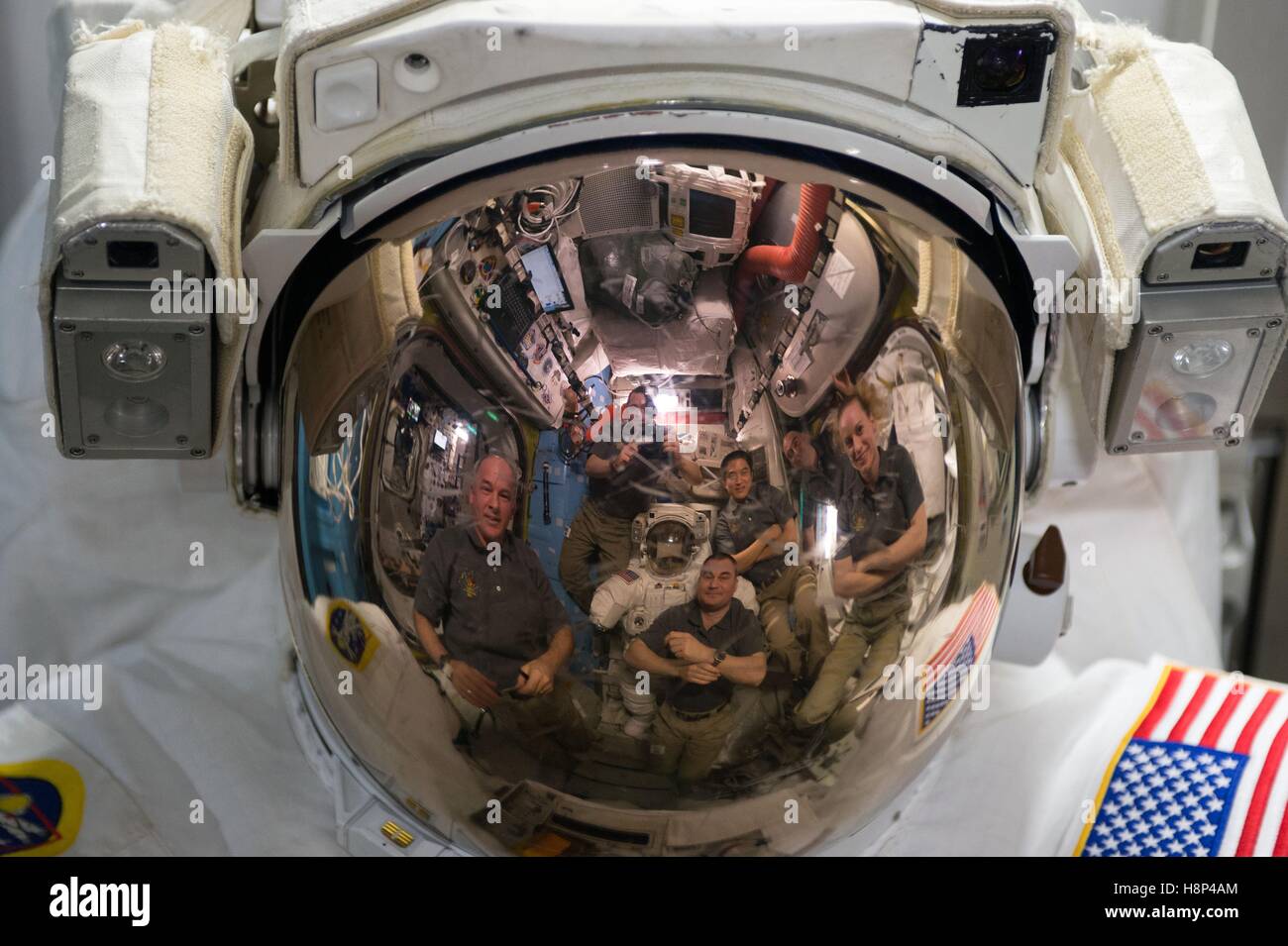A reflection of NASA International Space Station astronauts seen through a space station helmet visor September 3, 2016 while in Earth orbit. Stock Photo