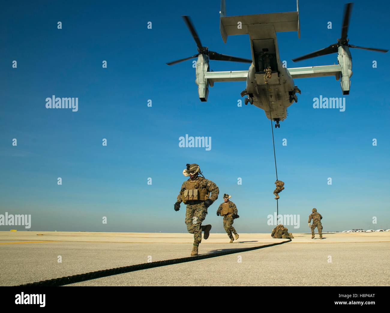U.S. Marine soldiers secure a landing zone from an MV-22 Osprey tiltrotor aircraft during insertion training at the Moron Air Base January 27, 2015 in Sevilla, Spain. Stock Photo