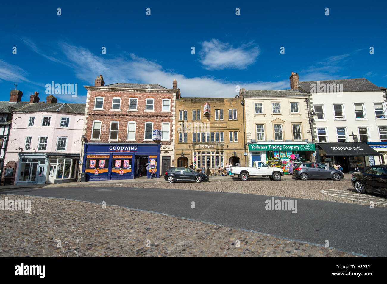UK, England, Yorkshire, Richmond - A strip of local shops in the city of Richmond located in Northern Yorkshire. Stock Photo
