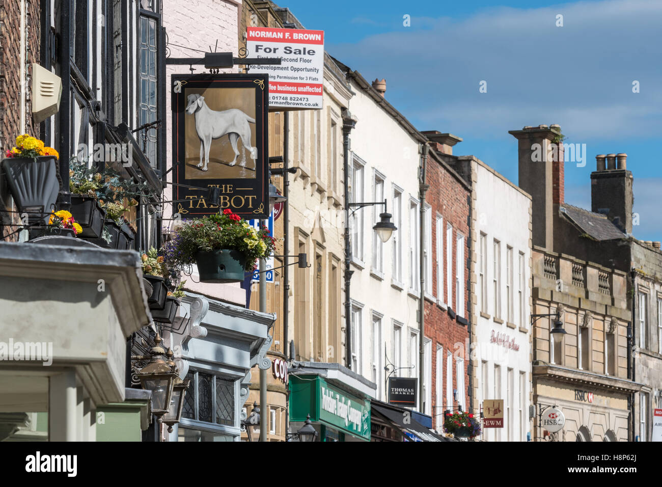 UK, England, Yorkshire, Richmond - A strip of local shops in the city of Richmond located in Northern Yorkshire. Stock Photo