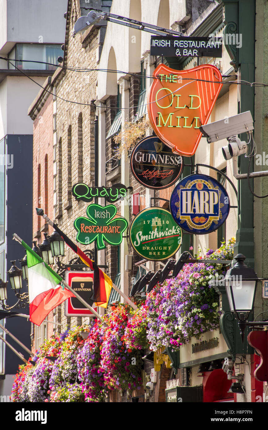 Dublin, Ireland Colorful neon bar signs and flags outside of a bar in