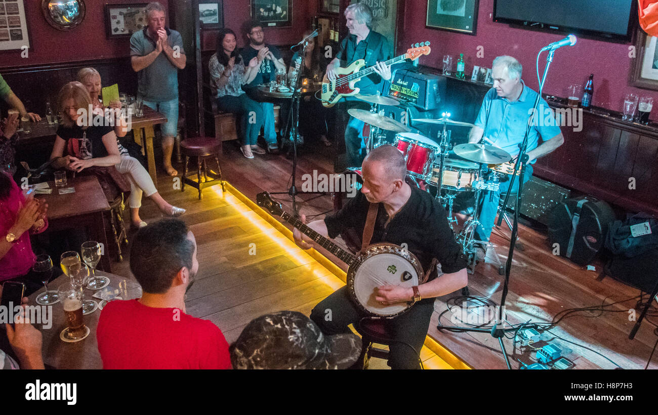 Dublin, Ireland- A band playing traditional Irish music in a local bar in the city of Dublin. Stock Photo