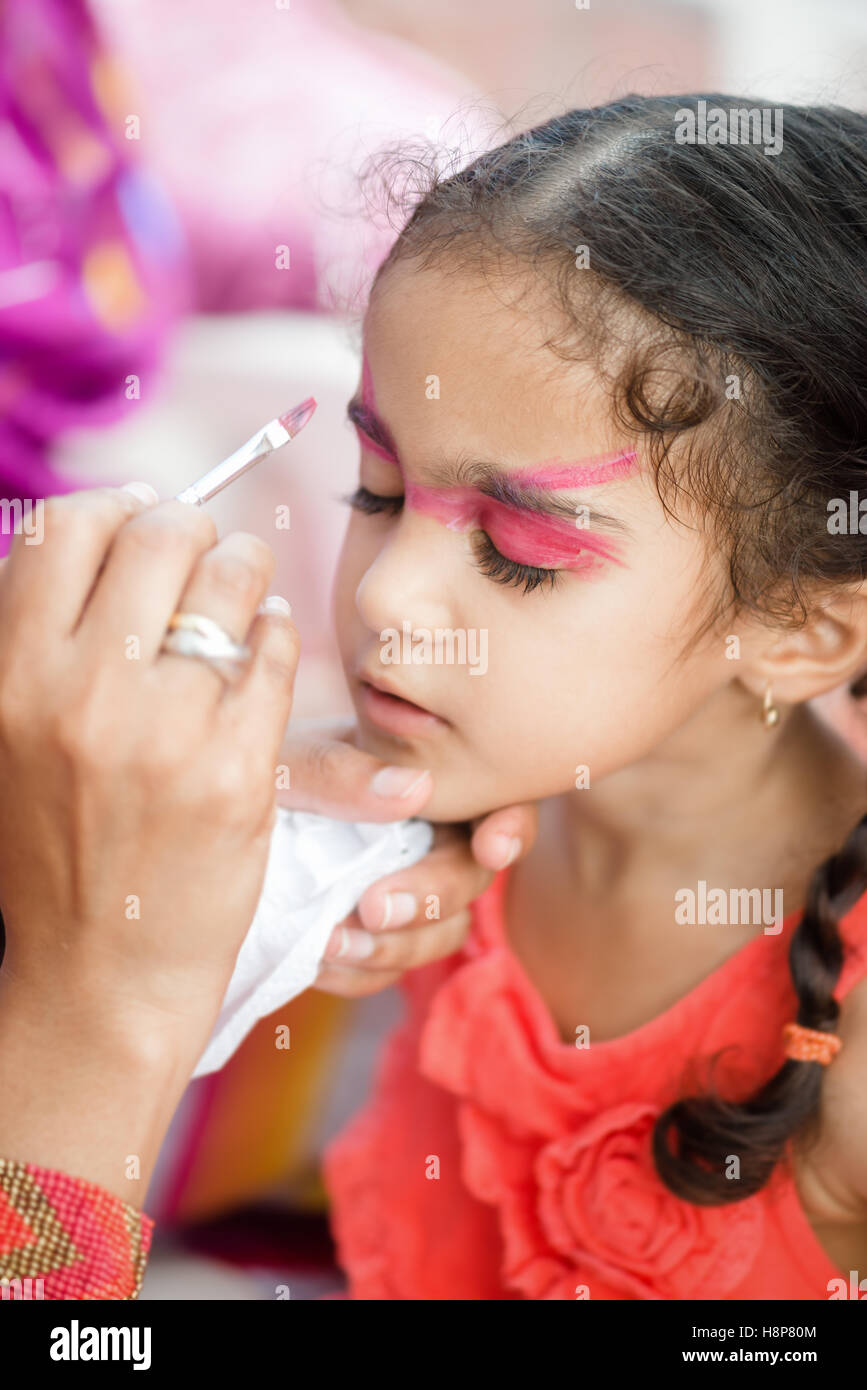 Four year old cute pretty girl child young with her face painted for fun at a birthday party Stock Photo