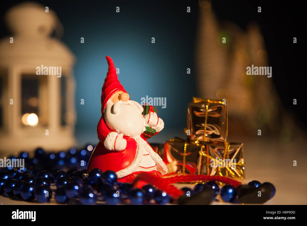Santa Claus with gifts lights background Stock Photo - Alamy