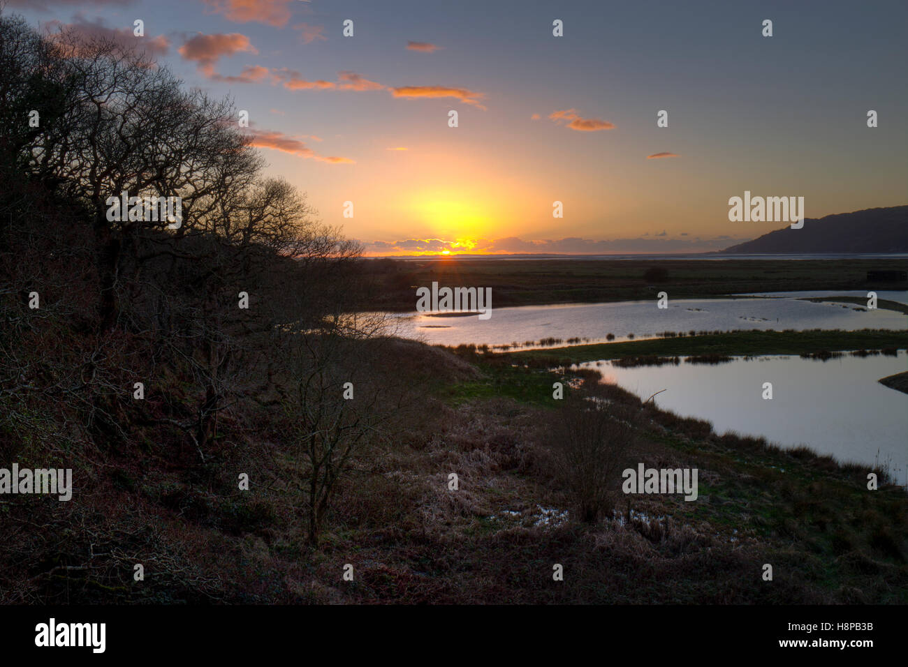 Sunset over freshwater pools and saltmarsh . RSPB Ynys Hir reserve. Ceredigion, Wales. February. Stock Photo