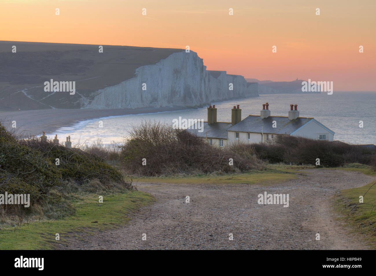 The Seven Sisters cliffs and coastguard cottages at dawn. From Seaford Head, South Downs, East Sussex, England. February. Stock Photo