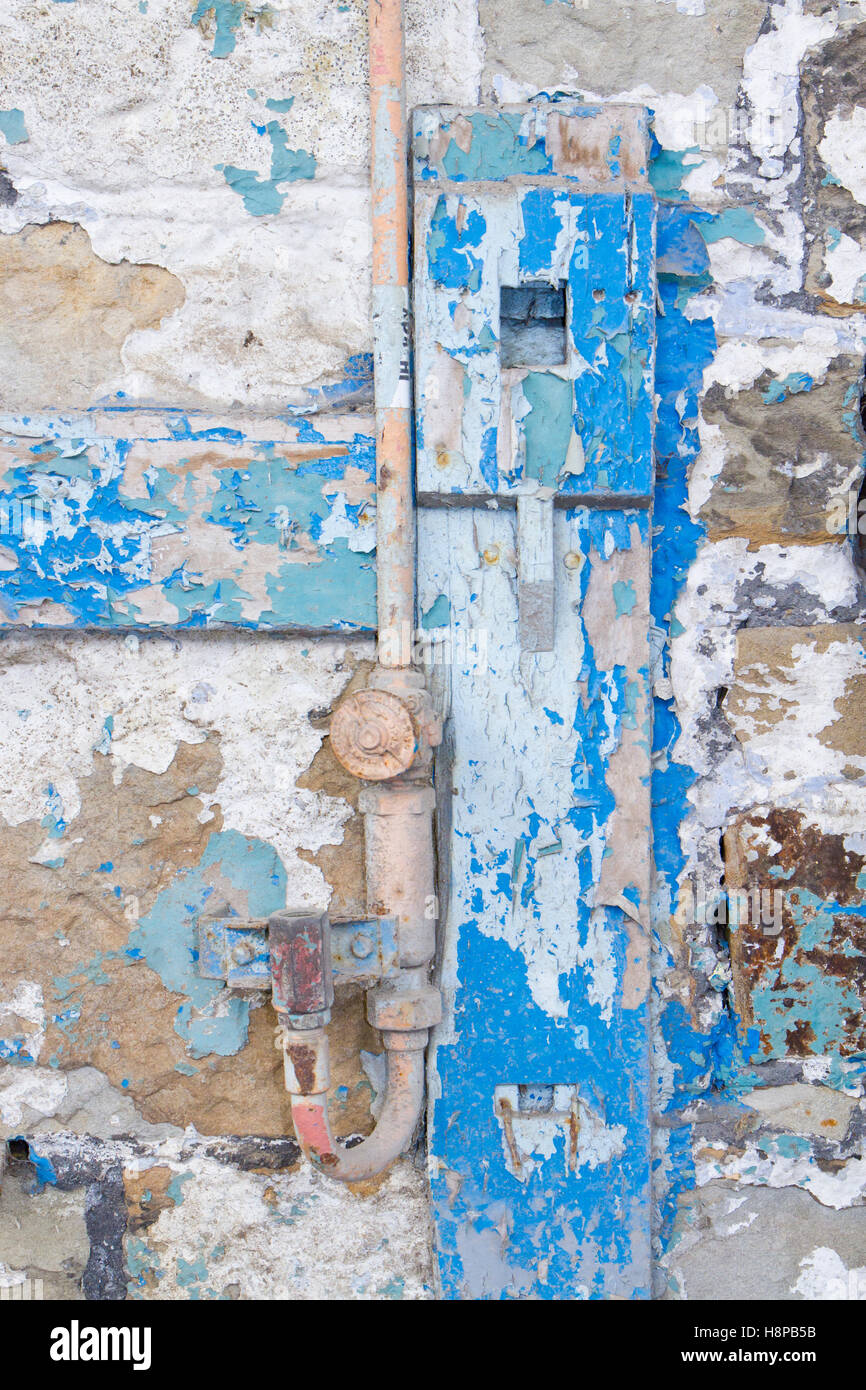 Bright colours of flaking paint on a disused foundry wall. Brymbo, Wrexham, Wales. Stock Photo