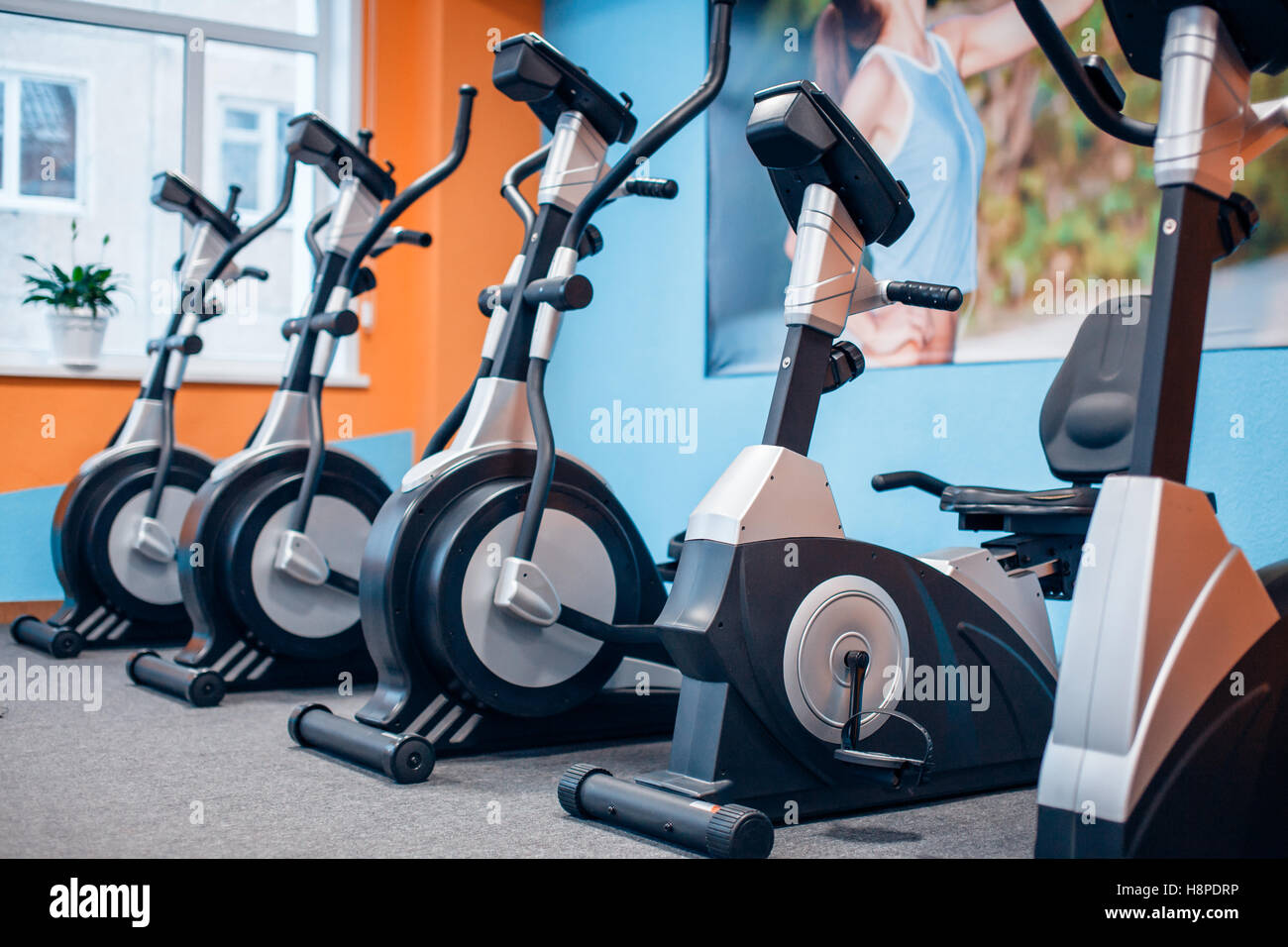 Five exercise bike in the gym Stock Photo