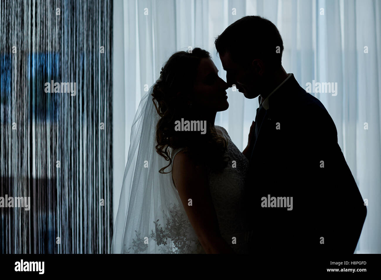 Silhouette love couples on a background window Stock Photo