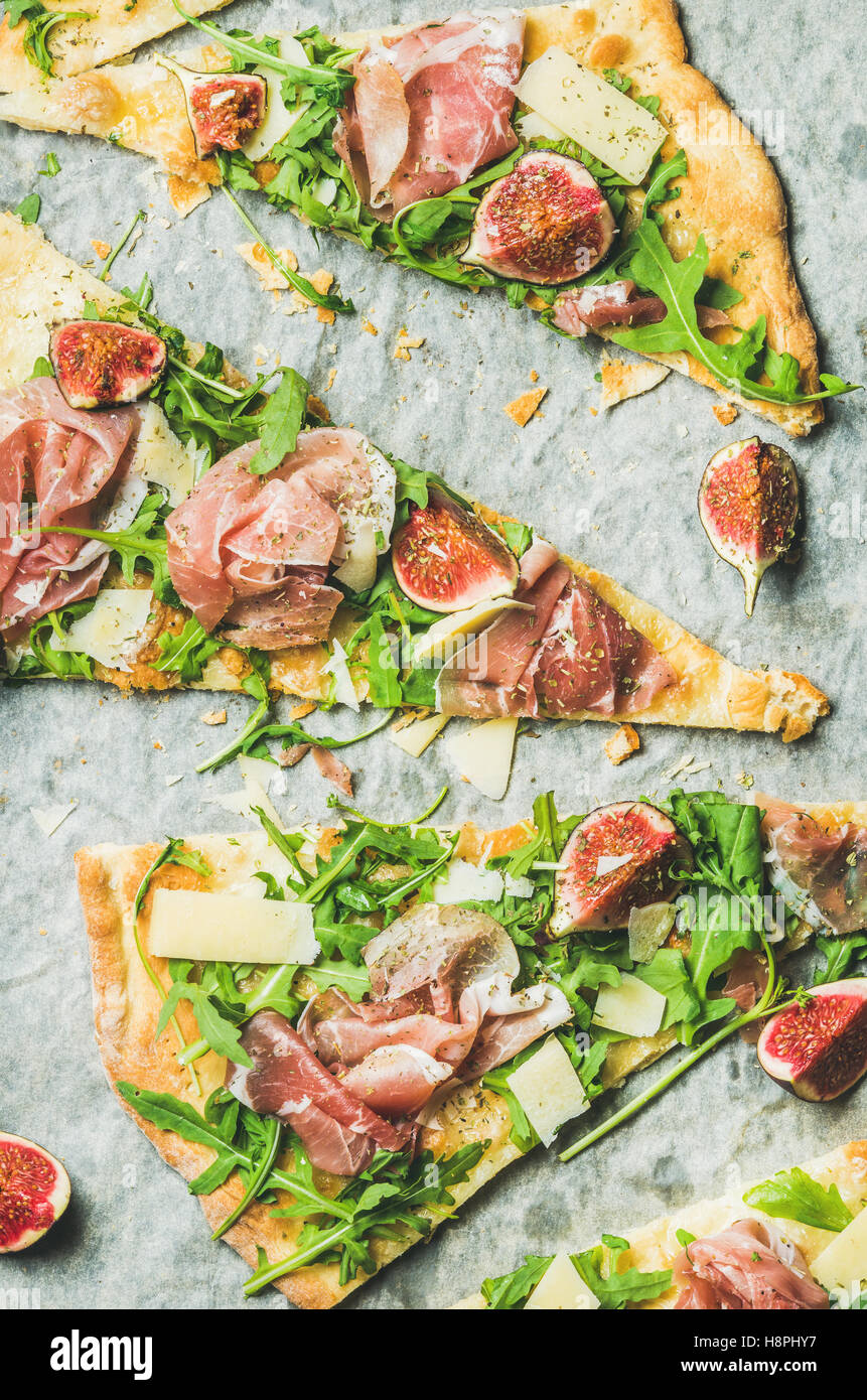 Pieces of fig, prosciutto, arugula and sage flatbread pizza Stock Photo