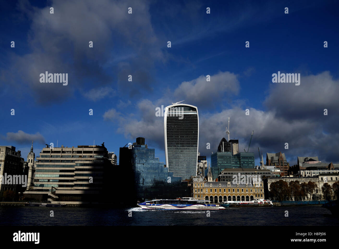 A Thames Clipper riverboat passes in front of the Walkie Talkie building, London Stock Photo