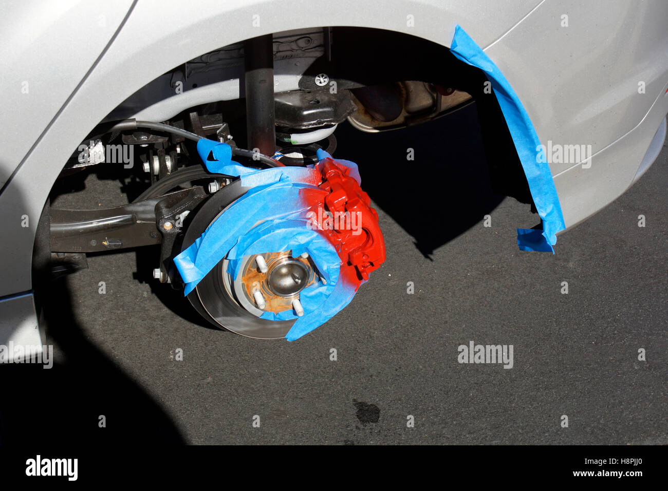 Painting a Disk Brake's Caliper Stock Photo