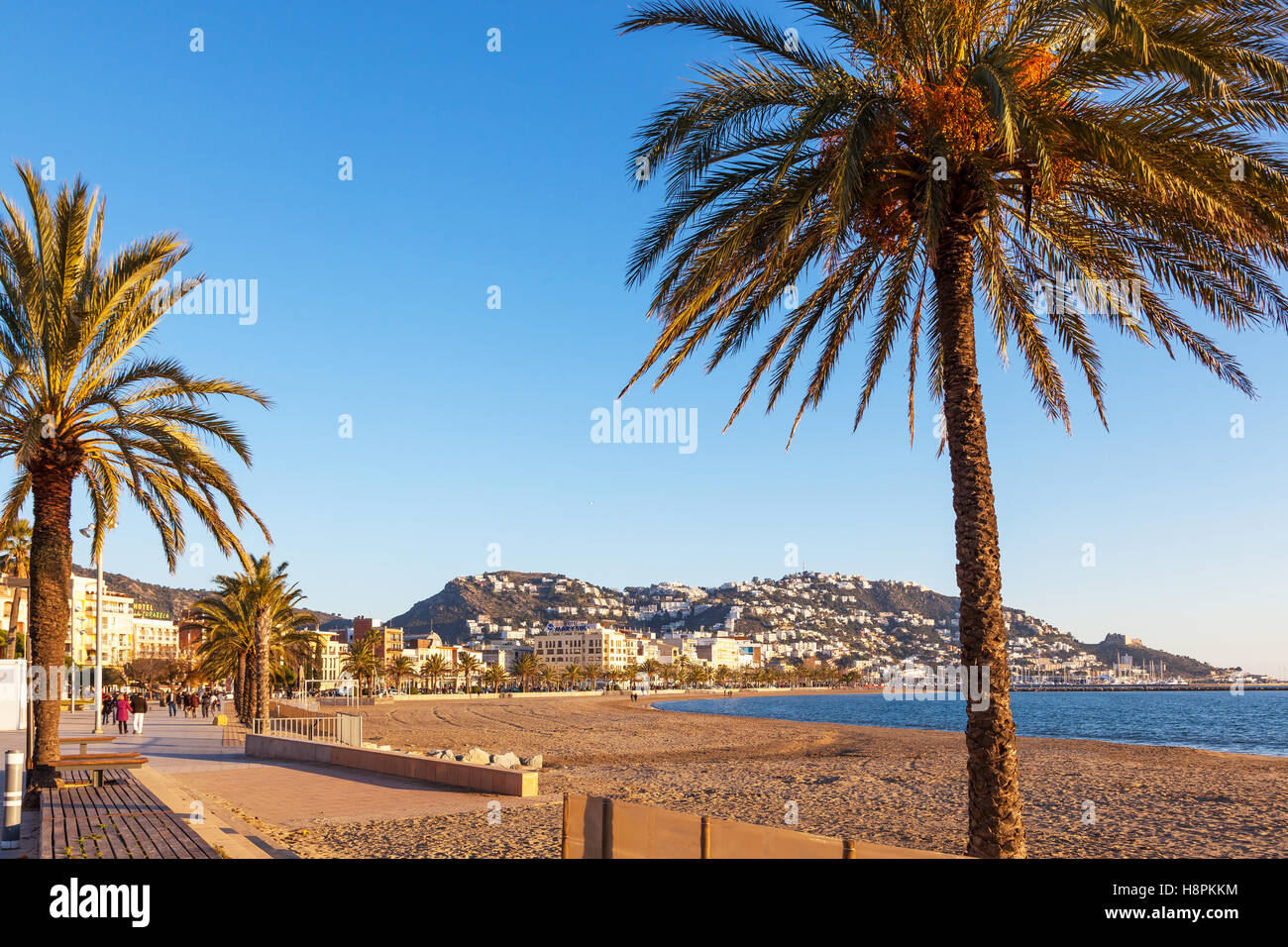 ROSES, GIRONA, SPAIN - JAN 22, 2012. Tourists strolling along the beach of  Roses in winter Stock Photo - Alamy