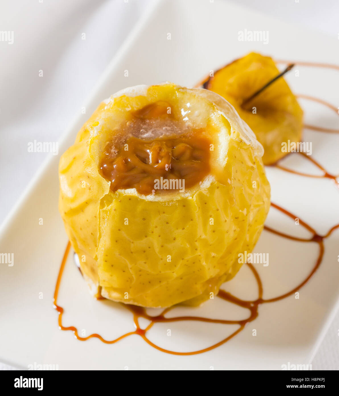 Oven baked apple filled with dulce de leche, a speciality from Argentina. Stock Photo