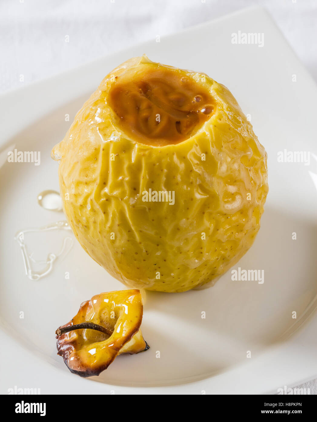 Oven baked apple filled with dulce de leche, a speciality from Argentina. Stock Photo