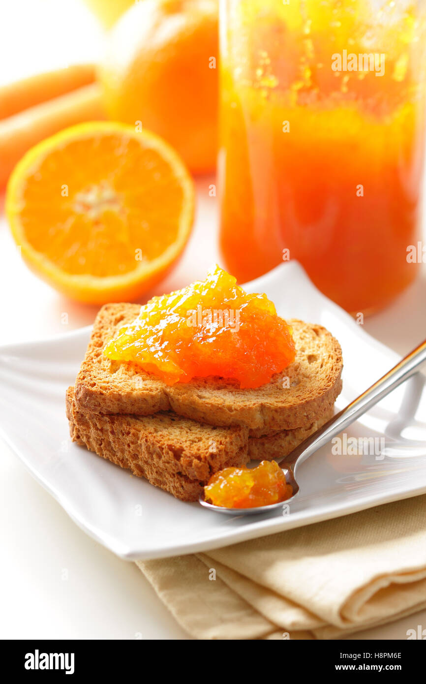 Homemade carrot and orange jam on toast for breakfast. Stock Photo